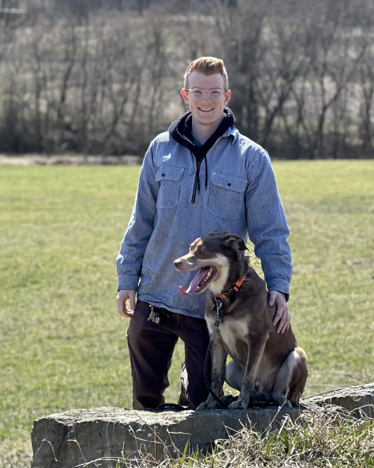 Joel, owner of JH Trailer Rental, with his dog outdoors