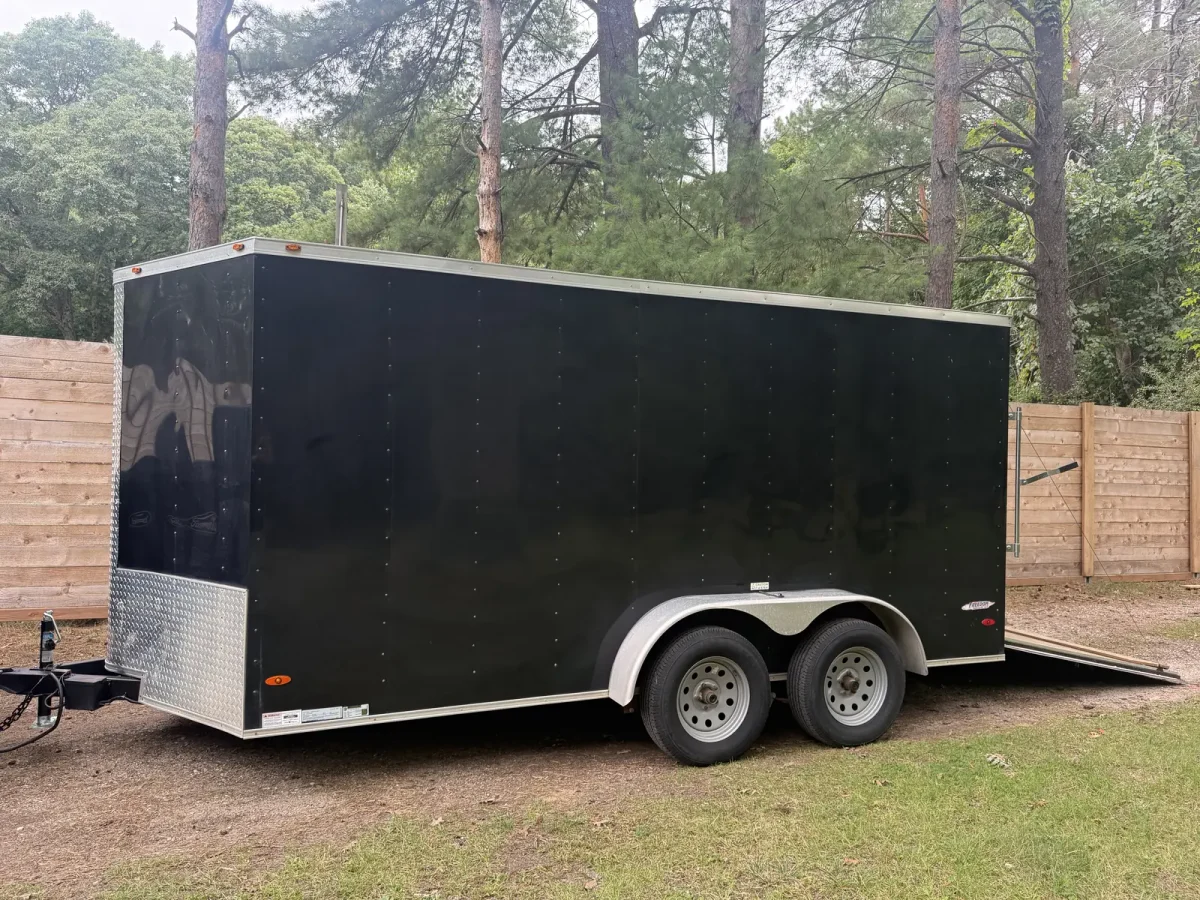 JH Trailer Rental’s black Freedom 7×14 enclosed cargo trailer in Newaygo, showing the front and tandem axles