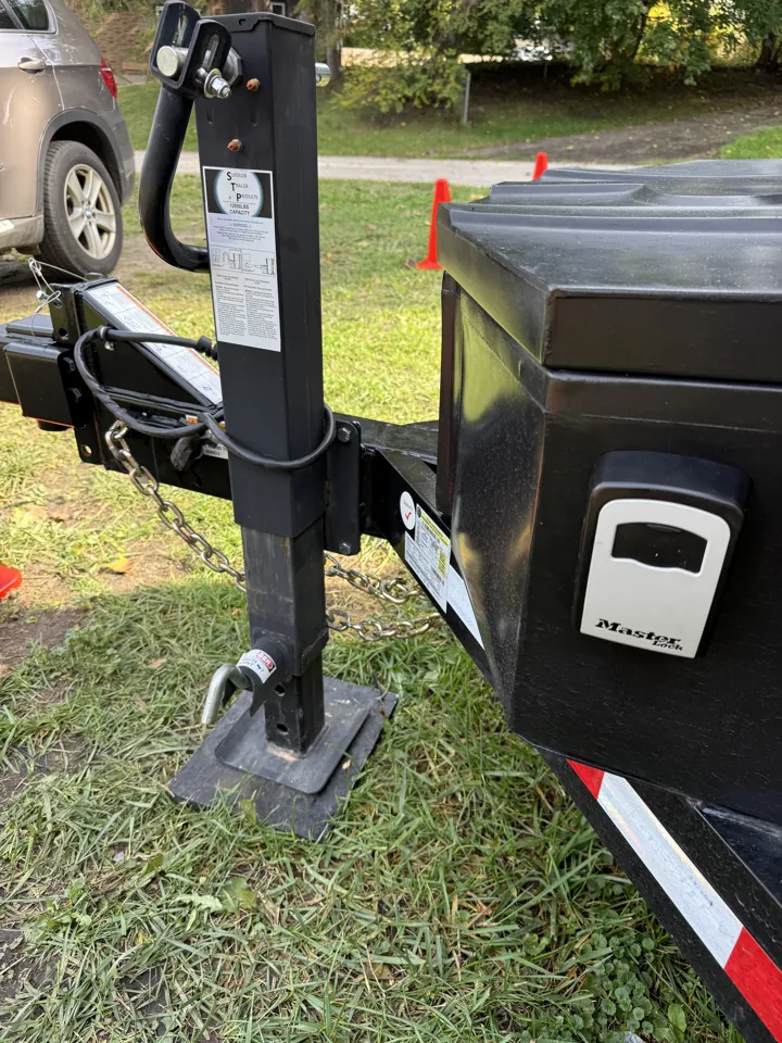 Dump trailer lockbox on the front storage box beside the jack
